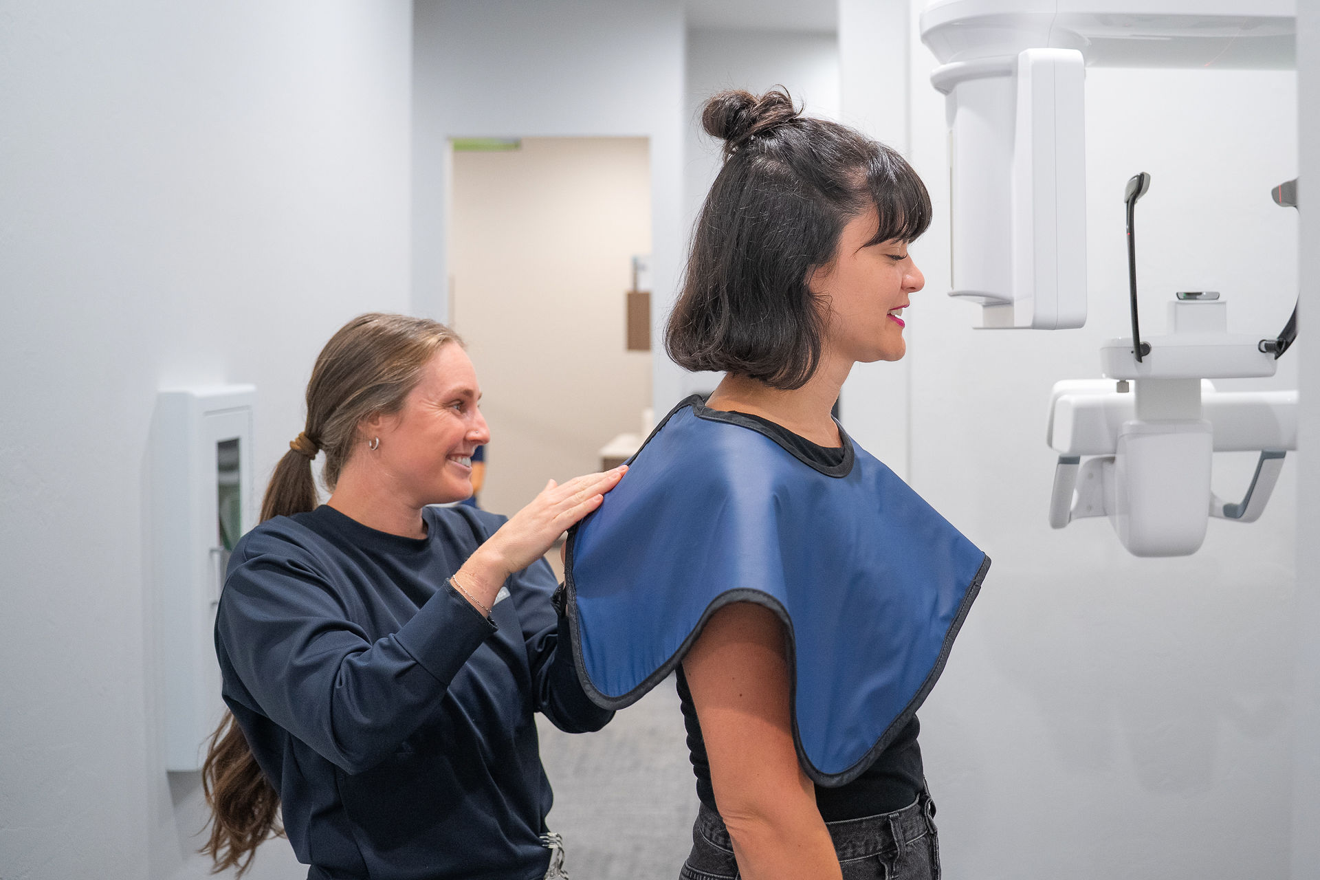 Dentist welcoming a patient into a modern dental office