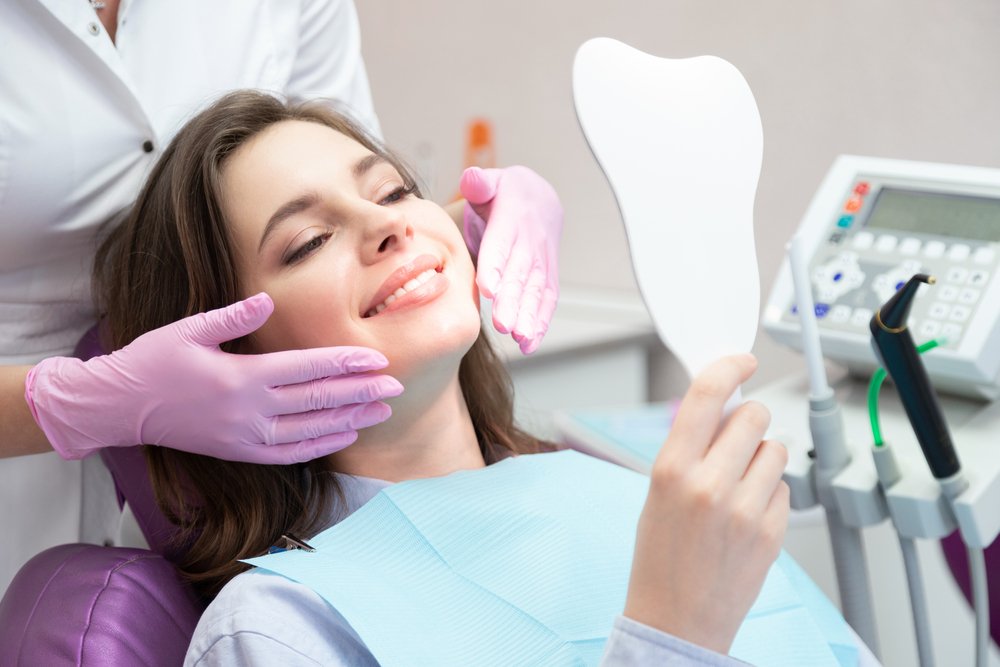 Patient viewing her smile during a cosmetic dentistry visit