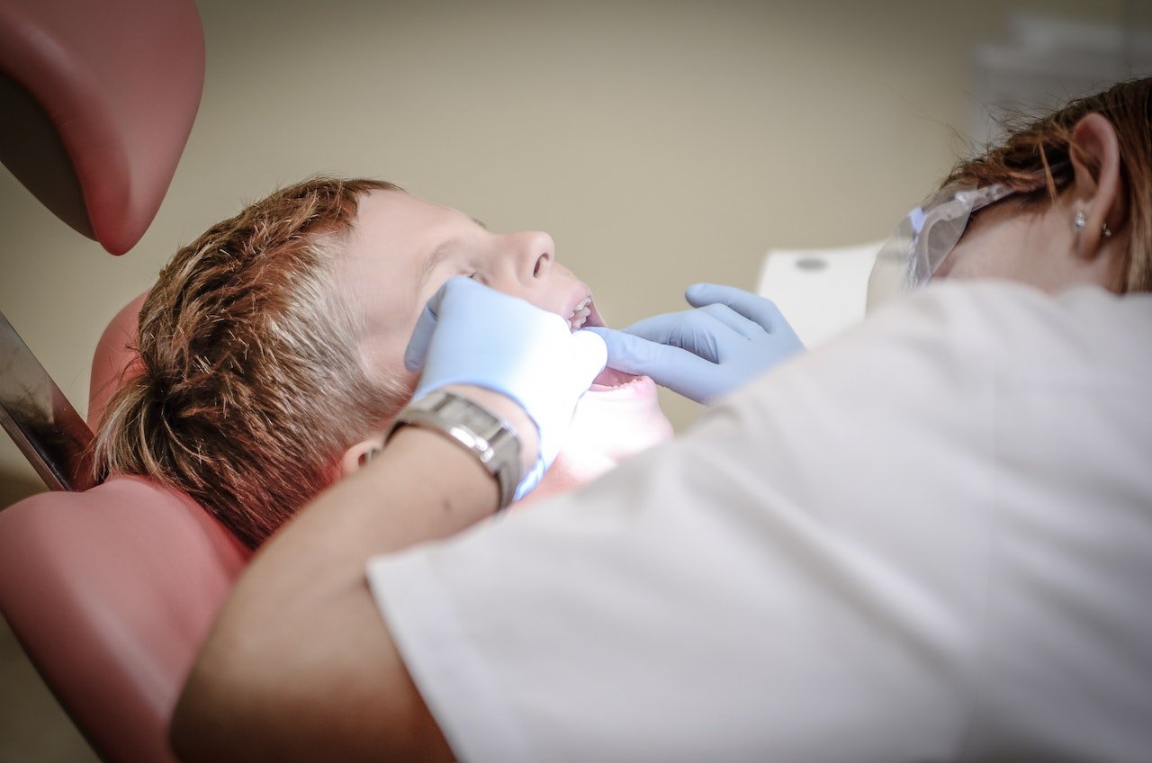 Patient receiving an oral examination from a dentist