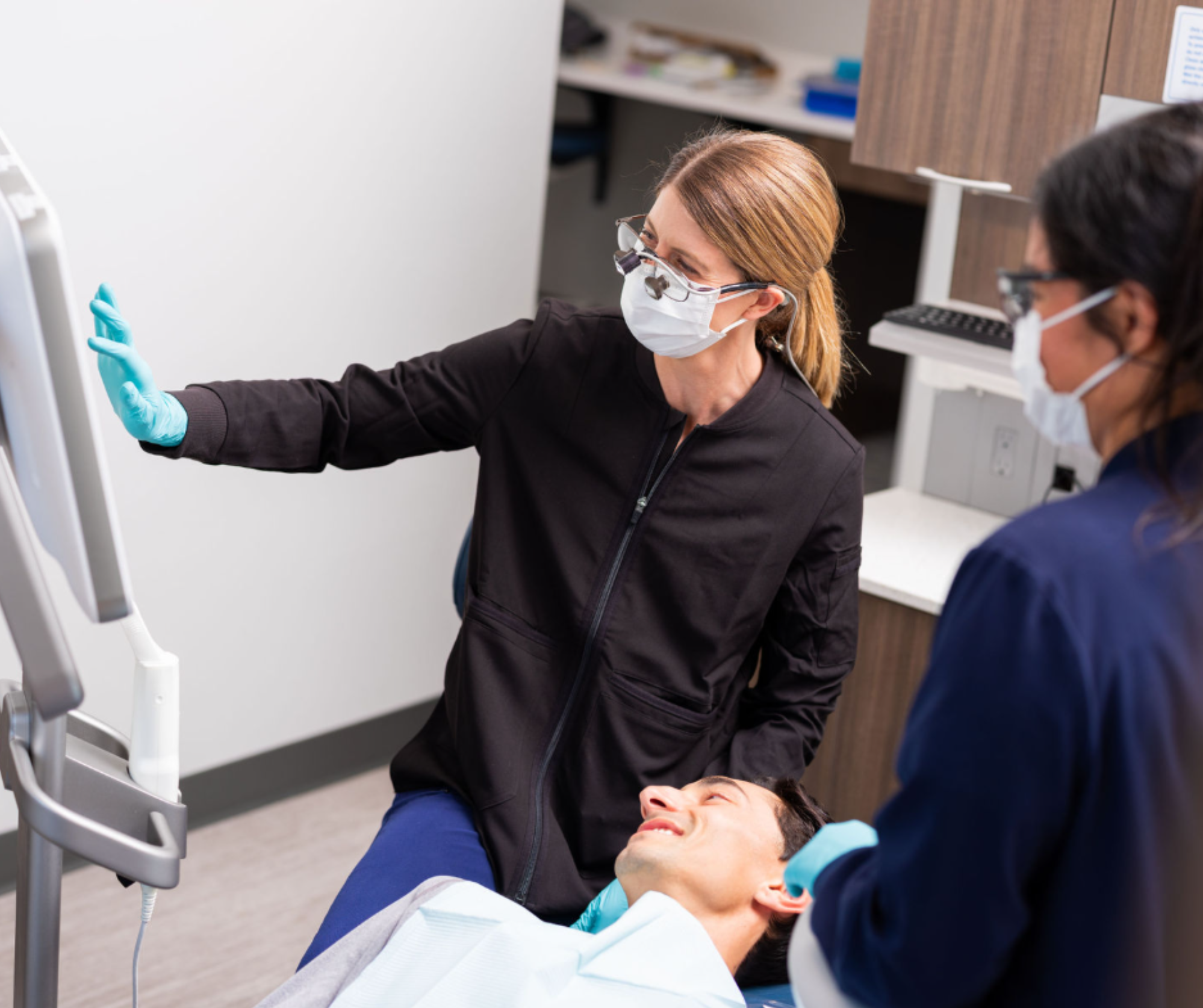 Dentist welcoming a patient into a modern dental office