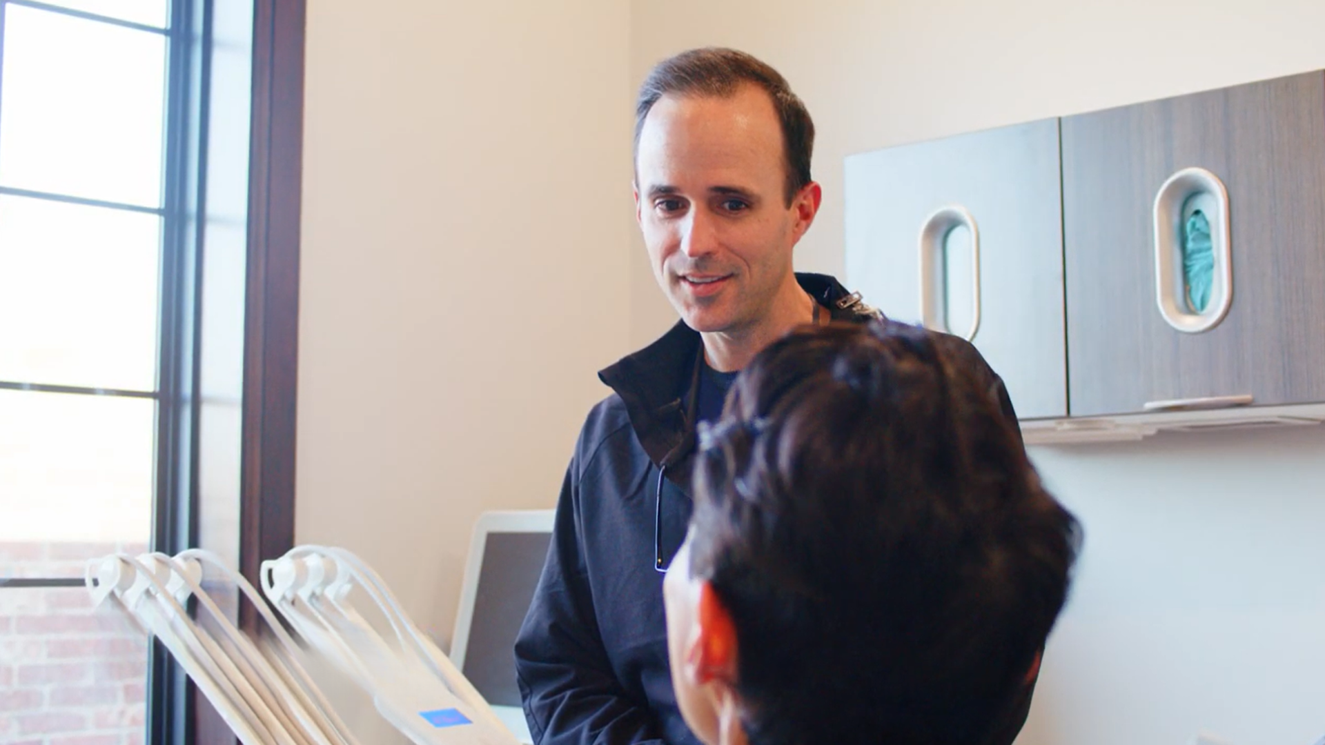 Dental professional examining a patient's teeth at Comprehensive Family Dentistry